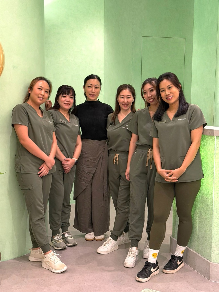 The Prologue clinic team in the clinic's sage-green reception.